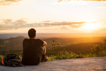Man looking at a sunset.