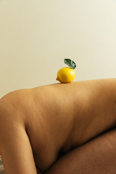 Bare back with lemon balanced on top