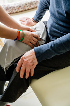 Physical therapist helping senior man patient