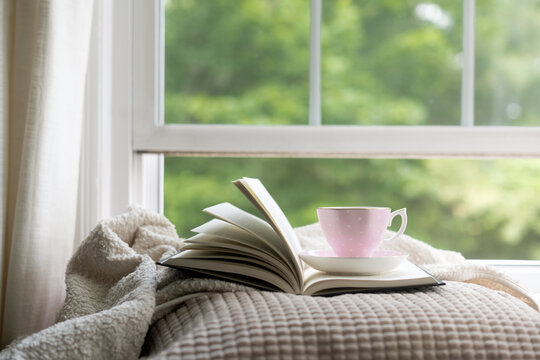Tea and book by window