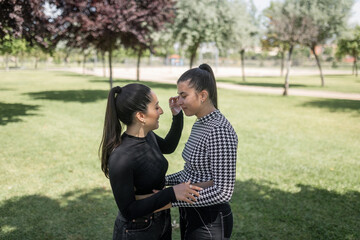 young lesbian couple together in a city park