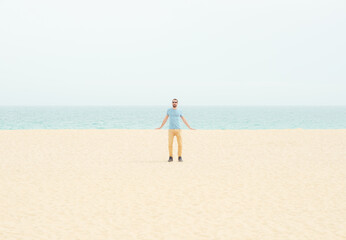 Man on the beach leaning on landscape