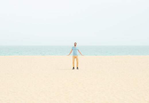 Man on the beach leaning on landscape