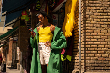 Fancy black man with phone at town