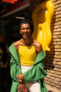 Content queer black man in timeless style by the city