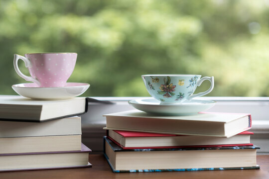 Tea cups and books by the window