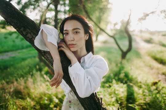 portrait of a young asian woman with the tree 
