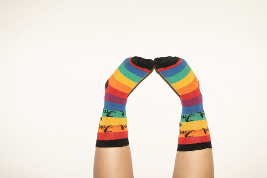 A anonymous person wearing rainbow socks - LGBT pride symbol