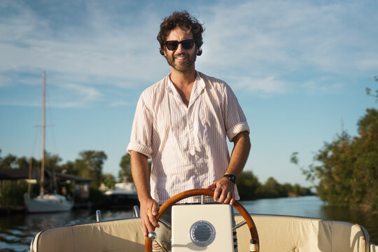 Smiling man boating on summer
