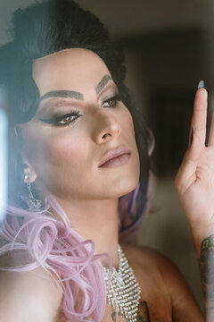 Portrait of a drag queen through a window