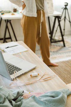Measuring tape near notepad and notebook in atelier studio