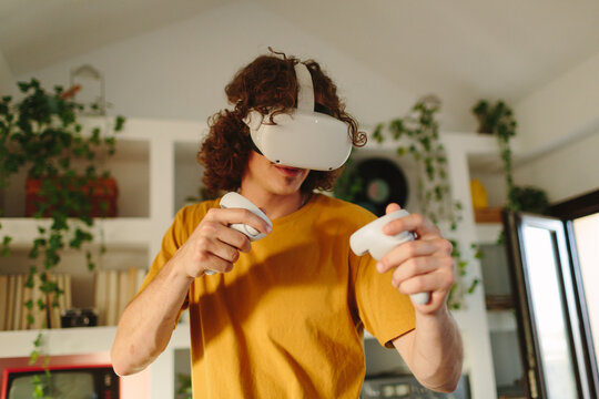 Young man playing with VR headset