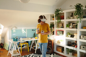 Young man streaming with virtual reality in a modern apartment