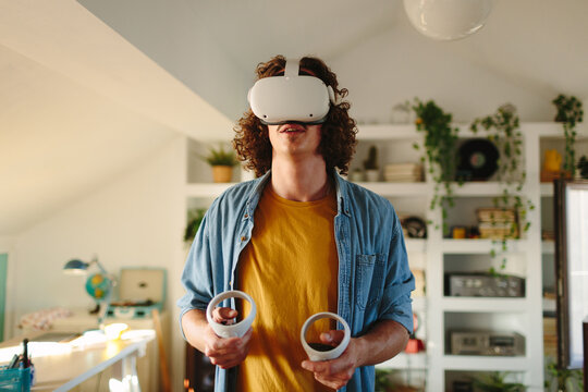 Man with long hair using VR headset for streaming