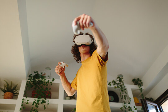 Low angle of a young male using virtual reality headset