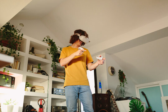 Low angle of a man streaming with VR headset