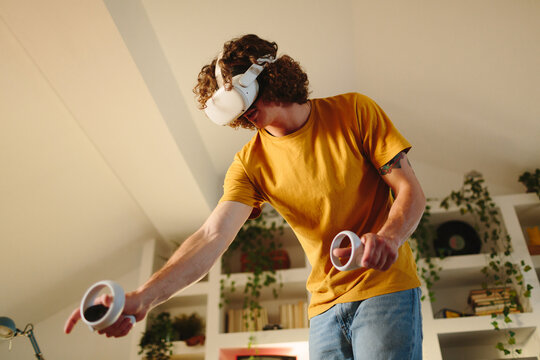 Man using VR games with headset and controllers