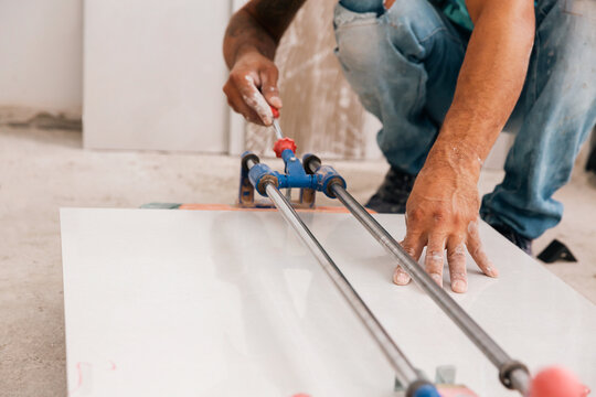 Man cutting porcelain tile