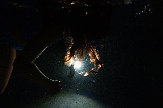 A weightless person floating below the surface