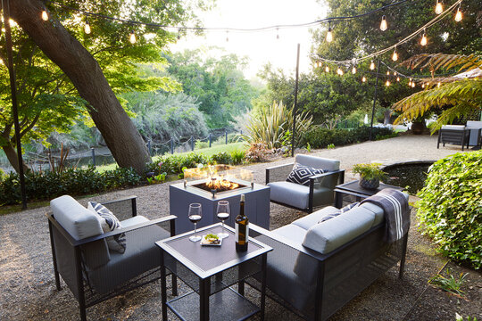 Outdoor lounge sitting area with fire pit and wine
