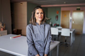 portrait of a young woman pastry chef in her business