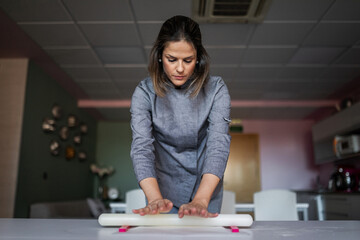 young woman pastry chef cooking in her business