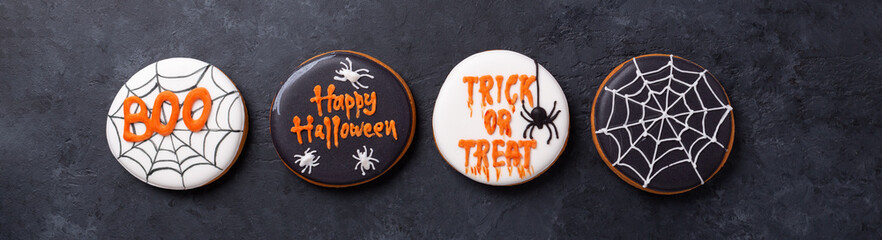 Set of Halloween gingerbread cookies on dark stone background. Bright homemade cookies for...