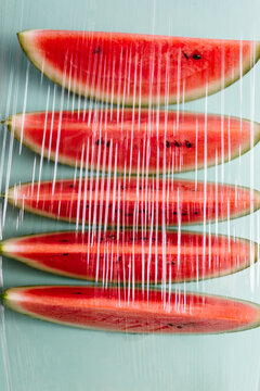 Slices of watermelon seen through a plastic film