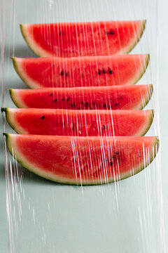 Slices of watermelon seen through a plastic film