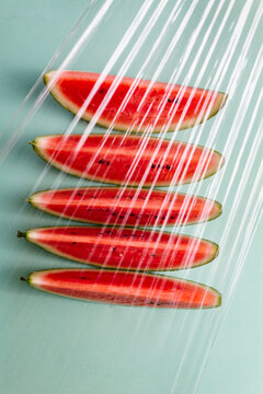 Slices of watermelon seen through a plastic film