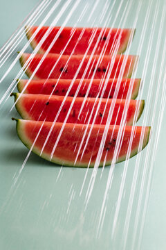 Slices of watermelon seen through a plastic film