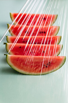 Slices of watermelon seen through a plastic film