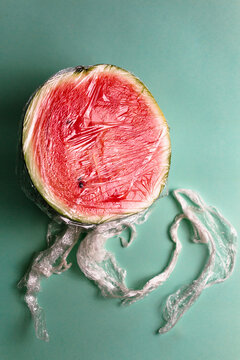 A watermelon covered by plastic