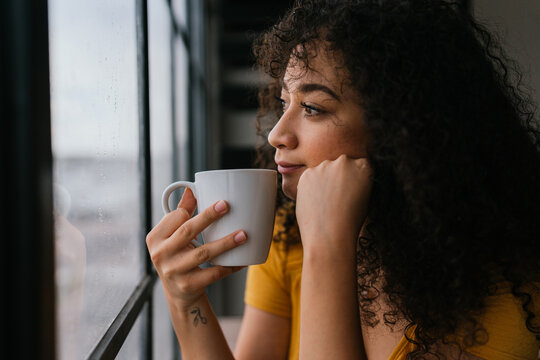Woman Looking The Rain Through the Window