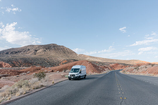 Camper van parked by desert highway