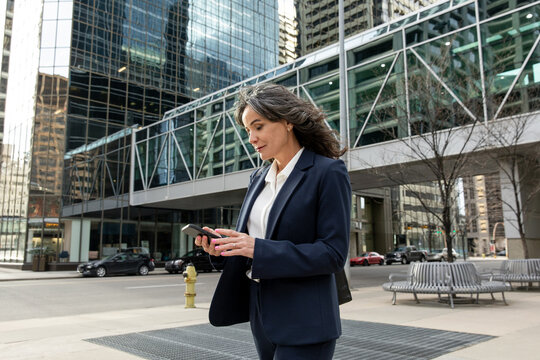 Confident Business Woman Looking At Her Phone Downtown