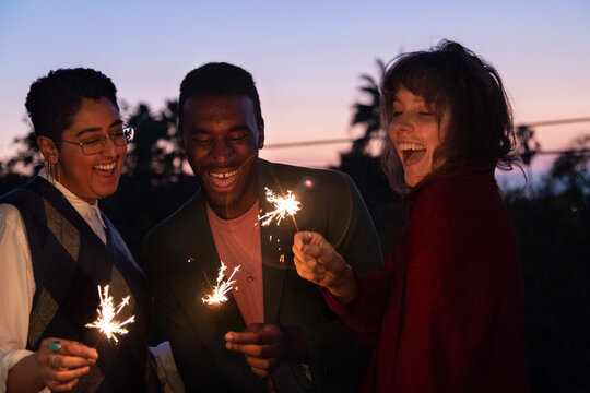 Non-binary friends with sparklers