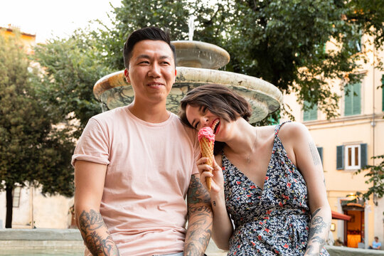 Couple eating melting gelato in Italy