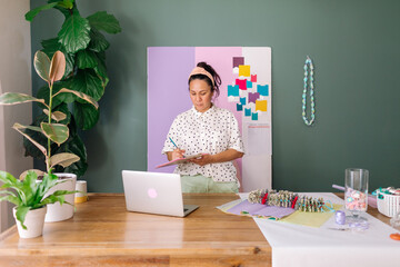 Female taking notes in craft studio