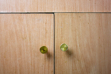 Old uneven cabinet doors with handles. Broken, dilapidated crooked furniture cabinet with handles...