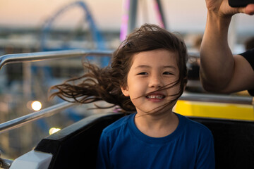 Happy kid on ferris wheel