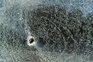 Bullet shattered glass.