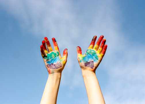 rainbow hands with blue sky