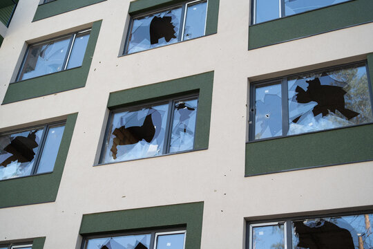 House with broken windows from a shell explosion.