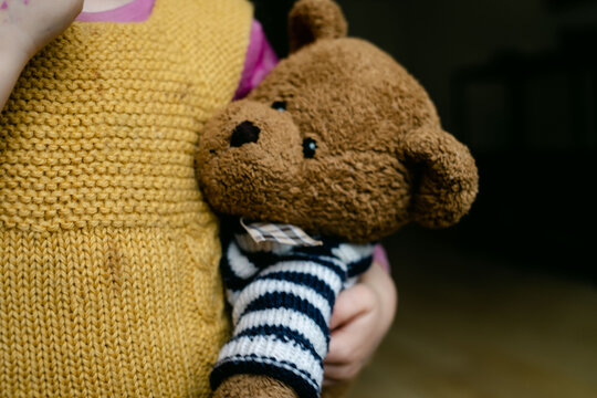 Naklejki teddy bear being held under arm