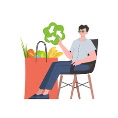 A man is sitting next to a bag of healthy food and is holding an EKO icon. Isolated. Trend style, vector illustration. - obrazy, fototapety, plakaty
