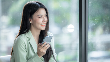 Beautiful asian businesswoman smile and using smartphone working, Smile beautiful business asian woman with suit working office using smartphonephone, Happy asian businesswoman using mobile phone.