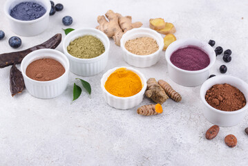 Various healthy superfoods powder in bowls