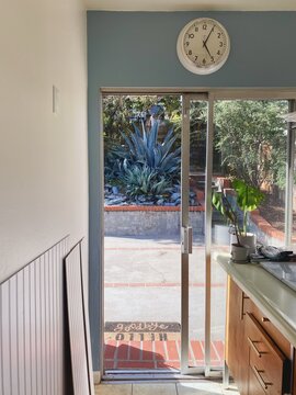 Blue Wall With Wall Clock And Wainscoting