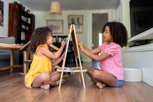 Sisters drawing at home